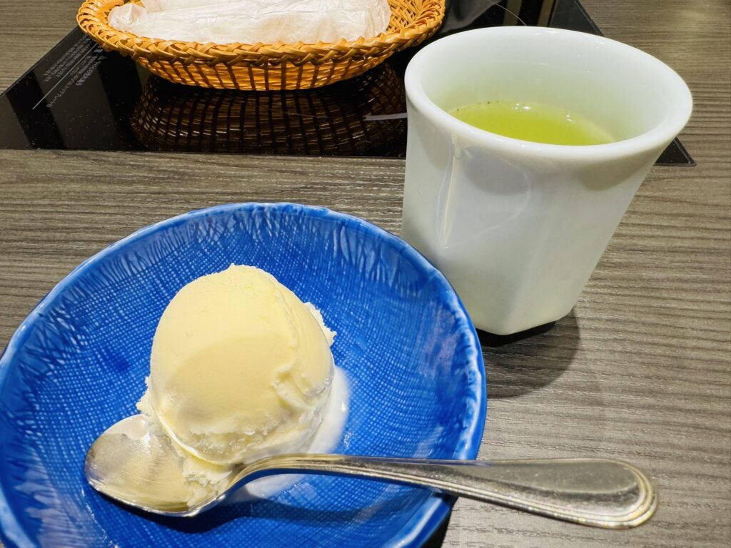 だしスープに入ったきしめんと餅を黄色い器で取り分けたところ